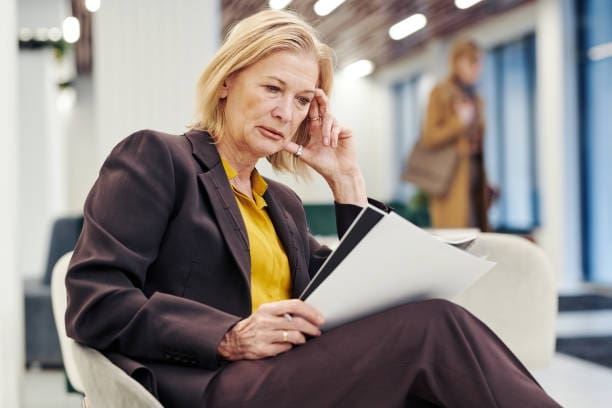 Woman Caregiver Reviewing Aging Parents Legal Documents